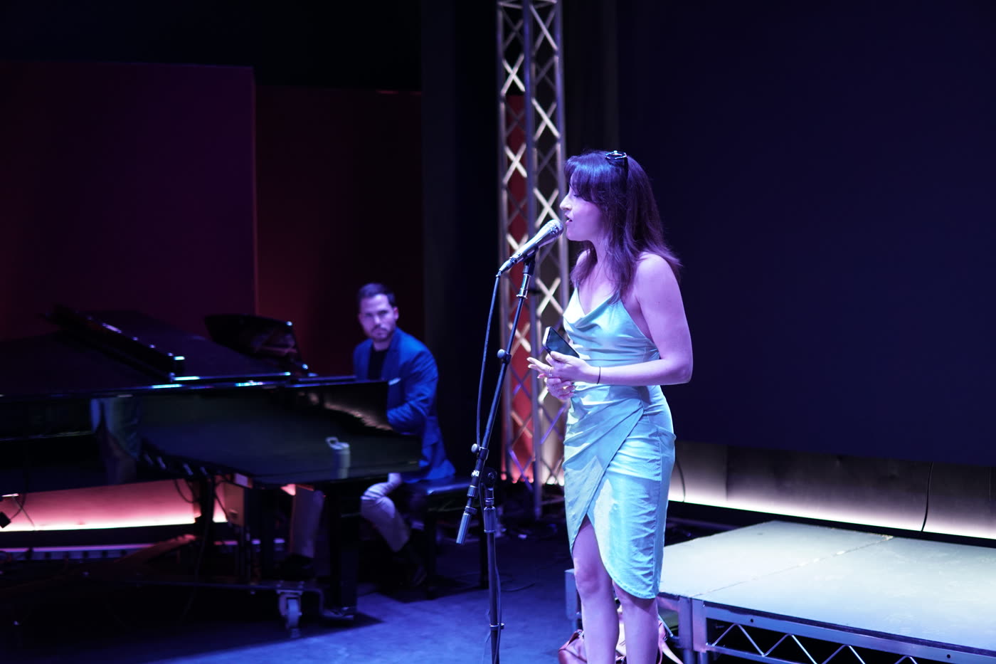 A vocalist and a pianist alone on the lit stage of the Live Room.